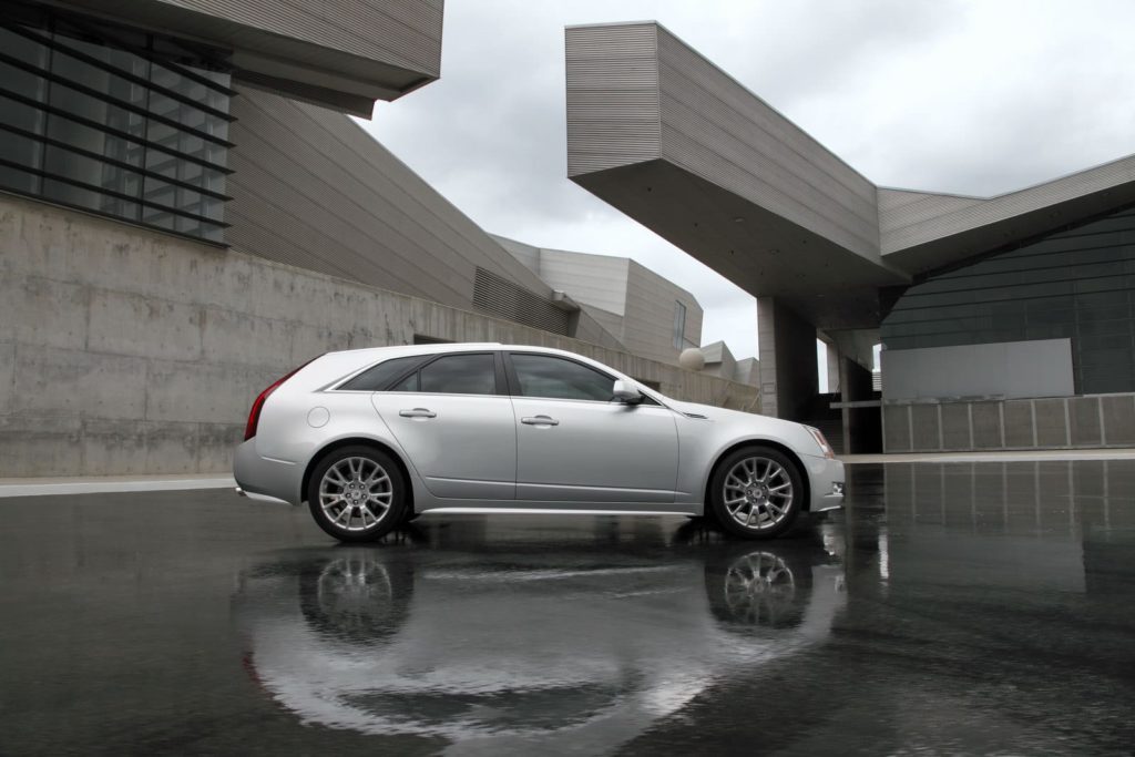 Silver car in a open space with water on the ground